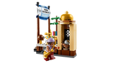 LEGO ONE PIECE Garp's Marine Battleship 75646 market scene featuring a Marine Victory Day anniversary banner, tan market booth, small tree and Usopp minifigure carrying a golden accessory.