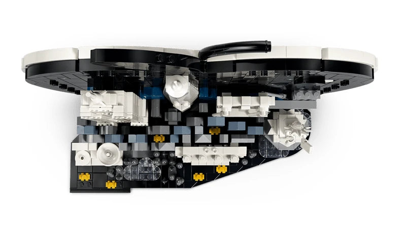 Overhead view of the LEGO Architecture New York City model showing the curved apple frame, white landmark structures, grey city buildings and yellow taxi details