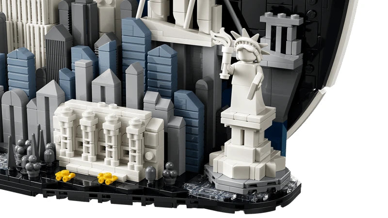 Close view of the LEGO Statue of Liberty and Metropolitan Museum of Art with blue and grey city buildings behind them