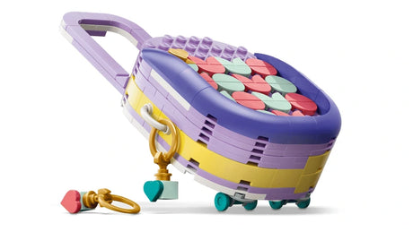 Side view of LEGO rolling suitcase build with patterned top, wheels and key chain accessories