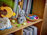 LEGO baby elephant display on a shelf beside a moon and star cloud build