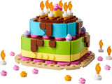 LEGO birthday cake model with candles, pink and yellow decorations and layered cake build
