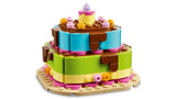 LEGO layered birthday cake build with brown, blue, green, yellow, pink and purple pieces
