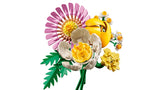 Assembled LEGO Botanicals Petite Sunny Bouquet 10347 showing pink gerbera flower, yellow tulip bud, white peony style flower, small yellow blossoms and green foliage on adjustable green stems