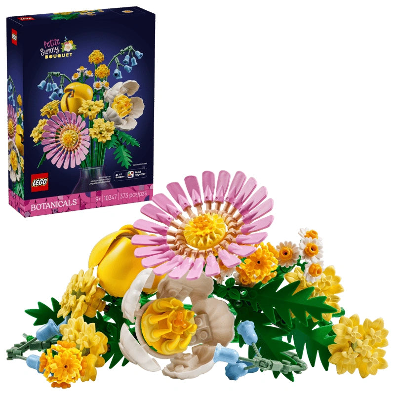 LEGO Botanicals Petite Sunny Bouquet 10347 retail box shown behind a completed pastel flower bouquet with pink gerbera, yellow flowers, white peony style bloom and green leaves on a white background