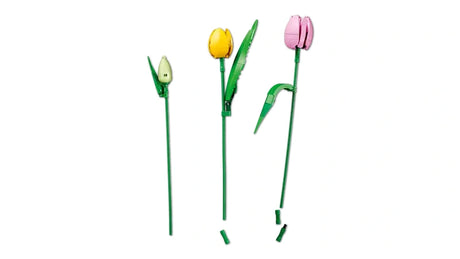 Three individual LEGO tulip stems showing a green bud, yellow tulip and pink tulip