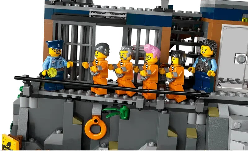 LEGO City 60419 prison breakout scene with officers escorting prisoners along the cell walkway on white background in Ireland