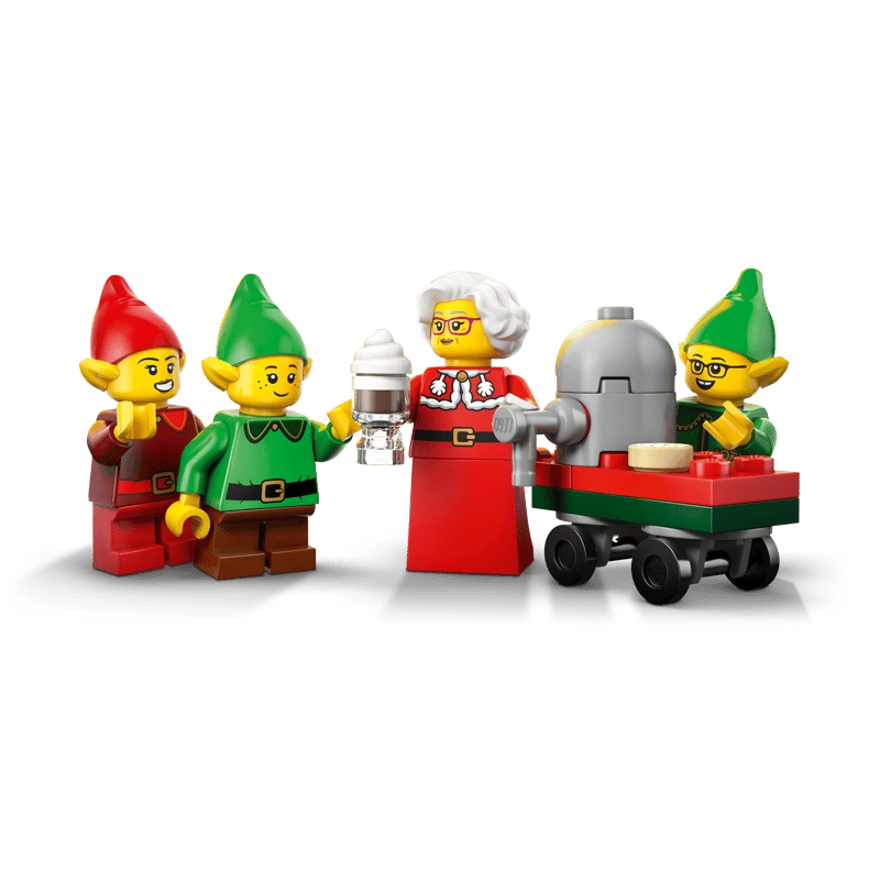 Mrs. Claus and three LEGO elves beside a red and green wheeled cart with a grey machine