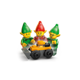 Three LEGO elf minifigures gathered around a small black and orange wheeled build