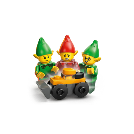 Three LEGO elf minifigures gathered around a small black and orange wheeled build