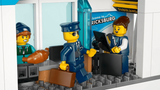 LEGO City airport check-in counter with airline staff minifigure, pilot minifigure and passenger luggage