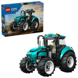 LEGO City Farm Tractor 60498 shown with retail box and assembled teal tractor featuring enclosed cab, front grille, exhaust pipe and four large black rubber tyres
