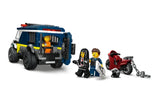 Rear view of the LEGO City police transport van with open jail cell, shown with a motorcycle and three minifigures standing nearby
