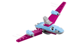 Close-up of pink flying dinosaur from LEGO Classic Creative Dinosaurs 11041 with outstretched wings, large eyes and white curved details