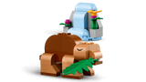 Brown LEGO Classic Creative Dinosaurs model holding a green leaf beside a blue waterfall with colourful flowers
