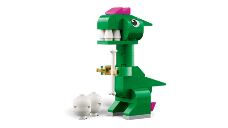 Green LEGO Classic Creative Dinosaurs T. rex model with white teeth, pink head details, short arms and a white dinosaur egg
