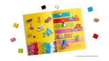LEGO building instructions booklet with loose bricks around it