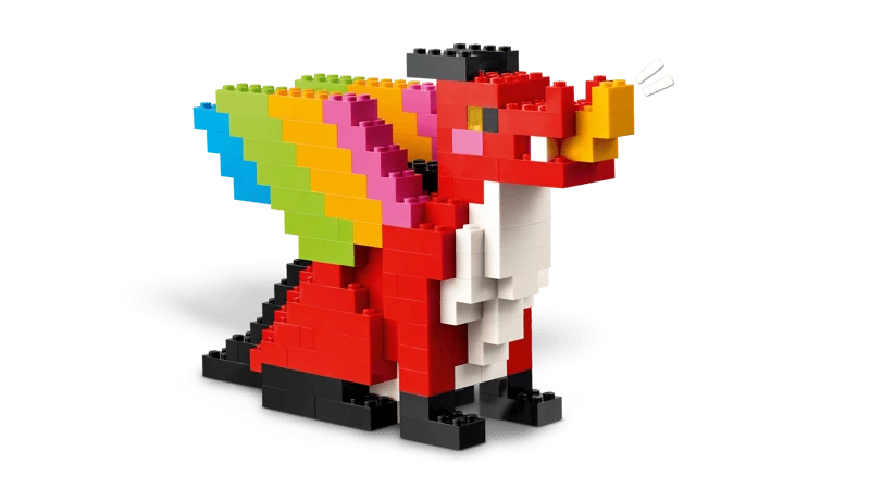 LEGO dragon build with red body, black legs and rainbow coloured wings