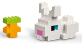 White LEGO animal build beside a small green and orange tree build