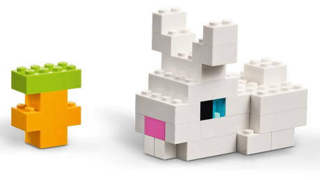 White LEGO animal build beside a small green and orange tree build