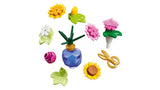 LEGO flower pieces with vase and gold scissors