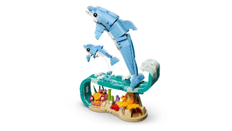 LEGO Creator 3 in 1 Sea Animals Beautiful Dolphins adult and baby dolphin models shown riding a wave on white background