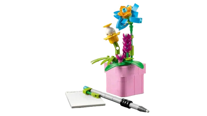 LEGO flower pot with flowers and a pen on a light gray background