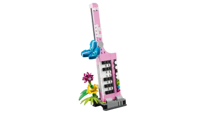 LEGO keytar guitar with pink case and blue pick on a white background