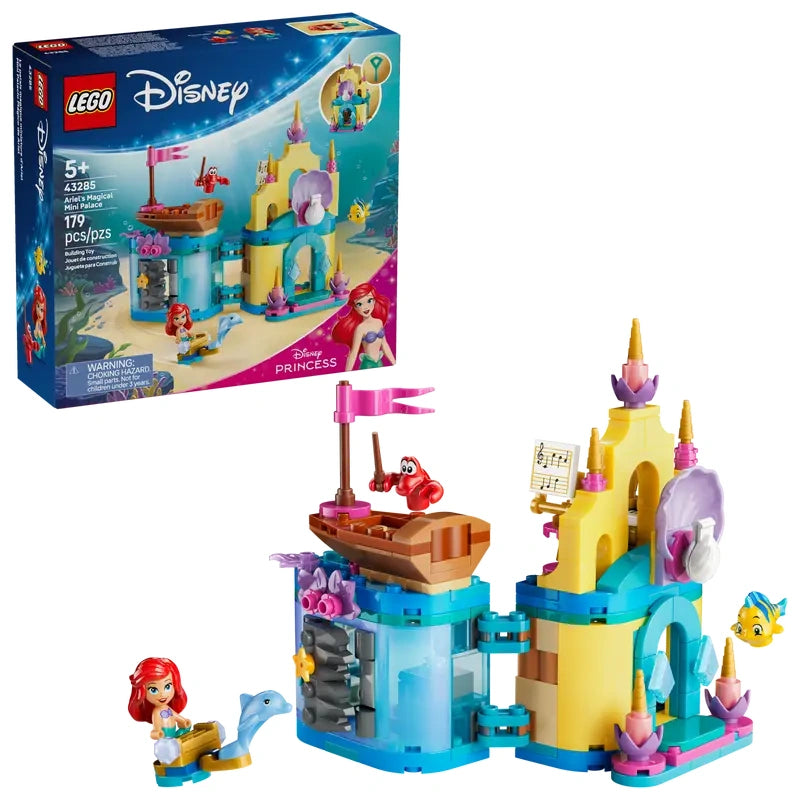 Retail box for LEGO Disney Ariel’s Magical Mini Palace shown beside the assembled mini palace with two connected towers, hinged sections and a small purple boat displayed in front on a white background