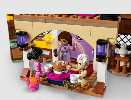LEGO characters dining with cake inside Asha’s Cottage set