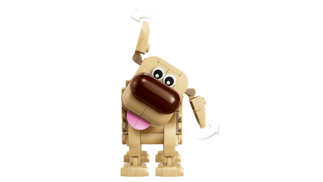 Front view of LEGO Disney Dug with his head tilted, pink tongue hanging out and one ear raised, with curved arrows indicating adjustable positions.