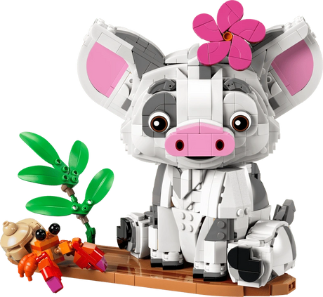 Completed LEGO Disney Pua 43292 model featuring the white and grey pig with large pink ears and a flower on its head, seated on a brown raft beside an orange hermit crab and green plants.