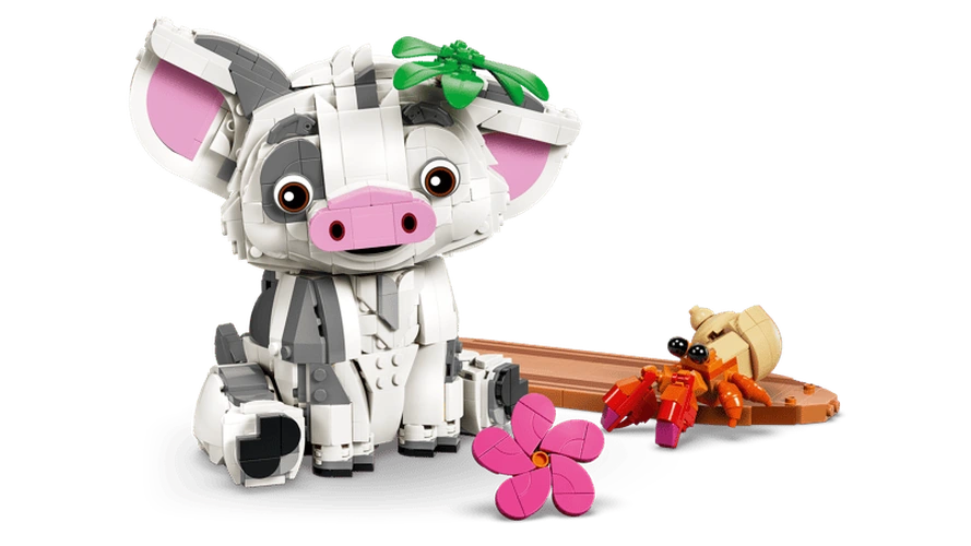 LEGO Disney Pua pig sitting beside a brown raft with an orange hermit crab, green leaf decoration on its head and a separate pink flower in the foreground.