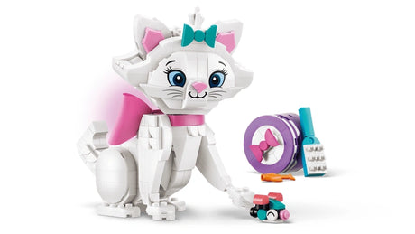 Assembled white brick built Marie cat with teal bow and pink tail shown with a purple gift box, blue brush, small mouse and fish accessories on a white background
