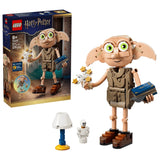 LEGO Harry Potter Dobby the Free Elf box beside built Dobby figure, lamp, white bottle accessory and blue book