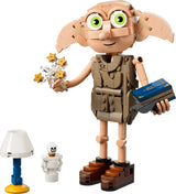 LEGO Dobby figure holding a blue book beside a lamp and white bottle accessory
