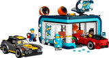 LEGO City drive-through car wash building with black and yellow car, red convertible, minifigure and blue water pieces