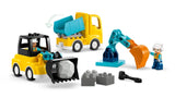LEGO DUPLO yellow dump truck, loader vehicle with black scoop, teal excavator arm and two DUPLO figures.
