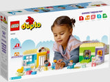 Child playing with LEGO DUPLO Town Life At The Day-Care Center 10992