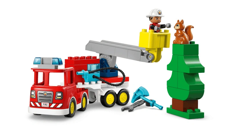 LEGO DUPLO red fire truck with ladder and firefighter figure beside a green tree build rescuing a squirrel figure