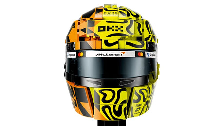 Front view of the LEGO Lando Norris Helmet showing the dark visor, McLaren branding and split orange, fluorescent yellow and black graphics