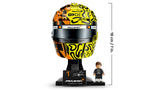 LEGO Lando Norris Helmet on its black McLaren display base beside the minifigure, with the completed model height marked as 18 cm