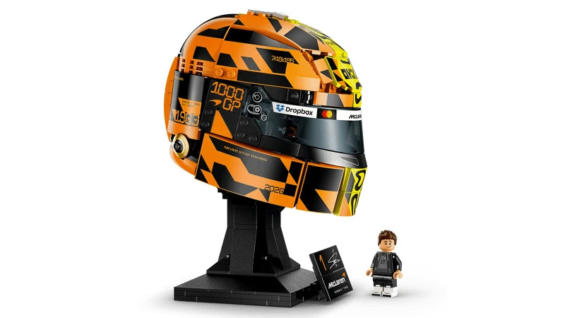 Orange and black side of the LEGO Lando Norris Helmet showing the 1000 GP graphics, dark visor, McLaren details, signature plaque and minifigure