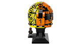 Rear view of the LEGO Lando Norris Helmet showing the split fluorescent yellow, black and orange design, number 1 detail and black display stand