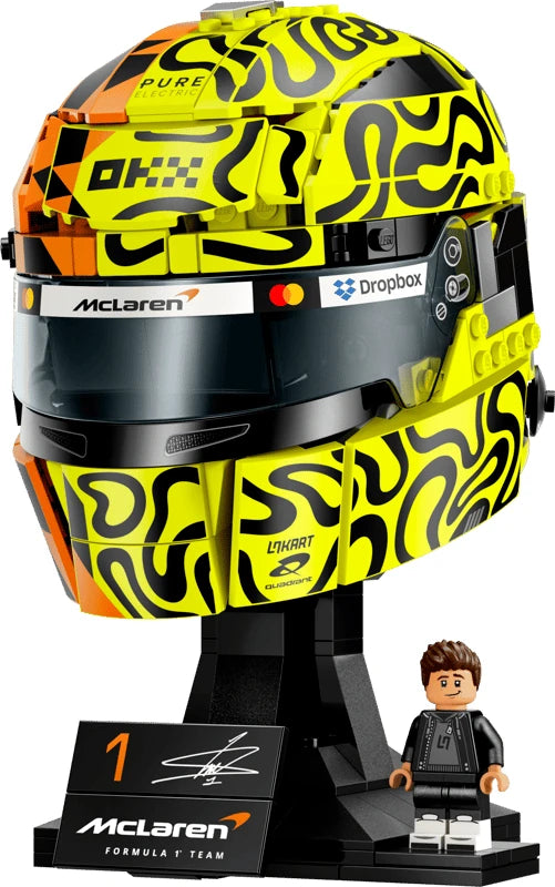 LEGO Lando Norris Helmet with fluorescent yellow, black and orange graphics on a black McLaren display base beside the Lando Norris minifigure