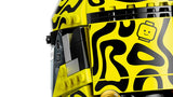 Close view of the fluorescent yellow and black patterned side of the LEGO Lando Norris Helmet with a small LEGO head graphic and black hinge details