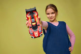 Child holding a LEGO Ferrari 499P race car model from the front