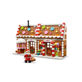 LEGO Festive Gingerbread House 40809 front view with Santa minifigure beside the decorated house