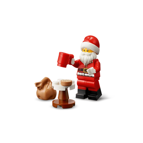 LEGO Santa minifigure holding a red mug beside a small table and brown sack
