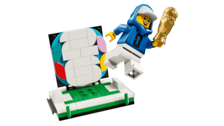 FIFA World Cup 2026 branded minifigure holding a mini gold trophy beside the removable display scene with multicolour 26 backdrop